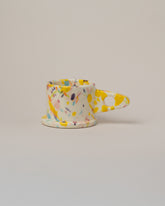 Echo Park Pottery by Peter Shire Yellow & Purple Splatter Mug on light color background.