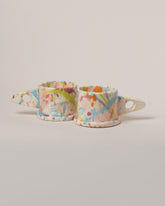 Echo Park Pottery by Peter Shire Pink & Sky Blue Splatter Mug Set on light color background.
