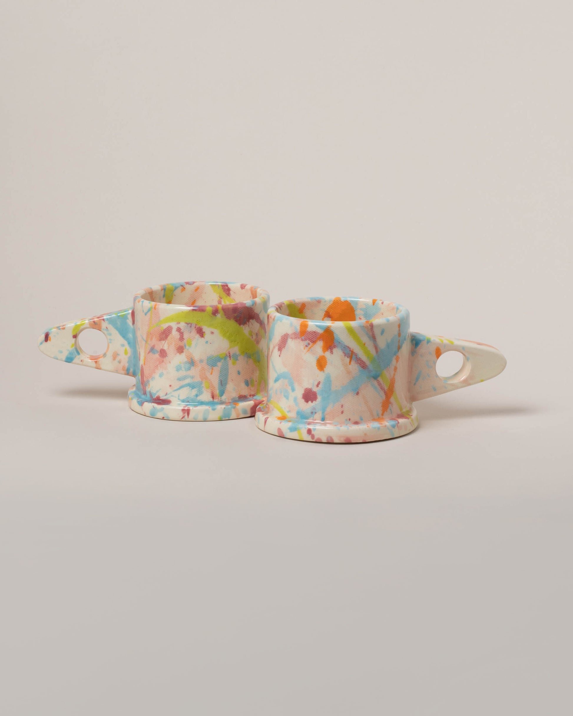 Echo Park Pottery by Peter Shire Pink & Sky Blue Splatter Mug Set on light color background.