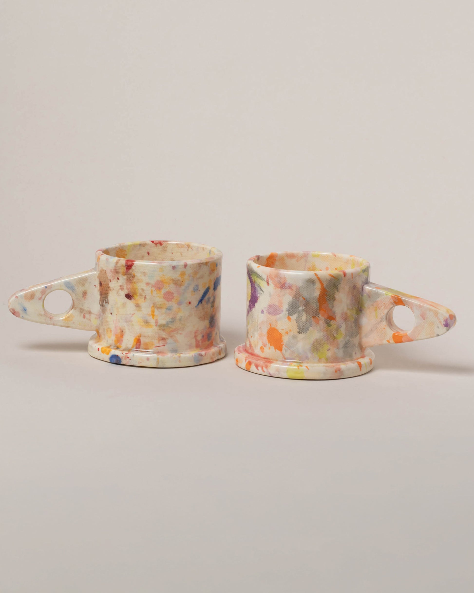 Echo Park Pottery by Peter Shire Rose & Blue Splatter Mug Set on light color background.