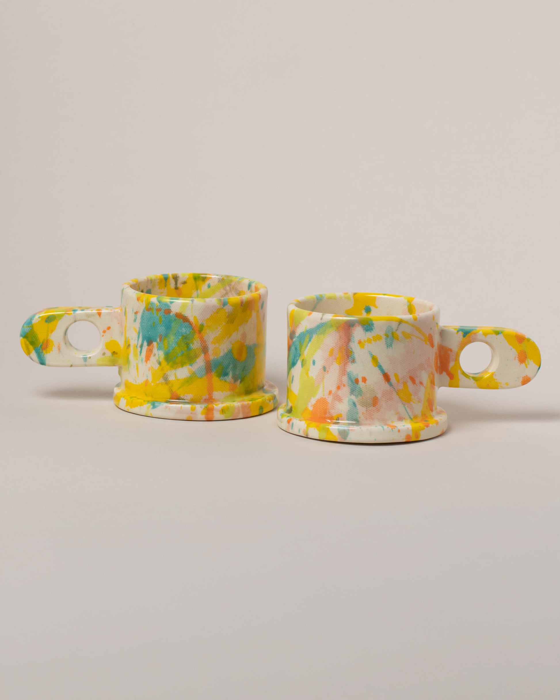 Echo Park Pottery by Peter Shire Teal & Yellow Splatter Mug Set on light color background.