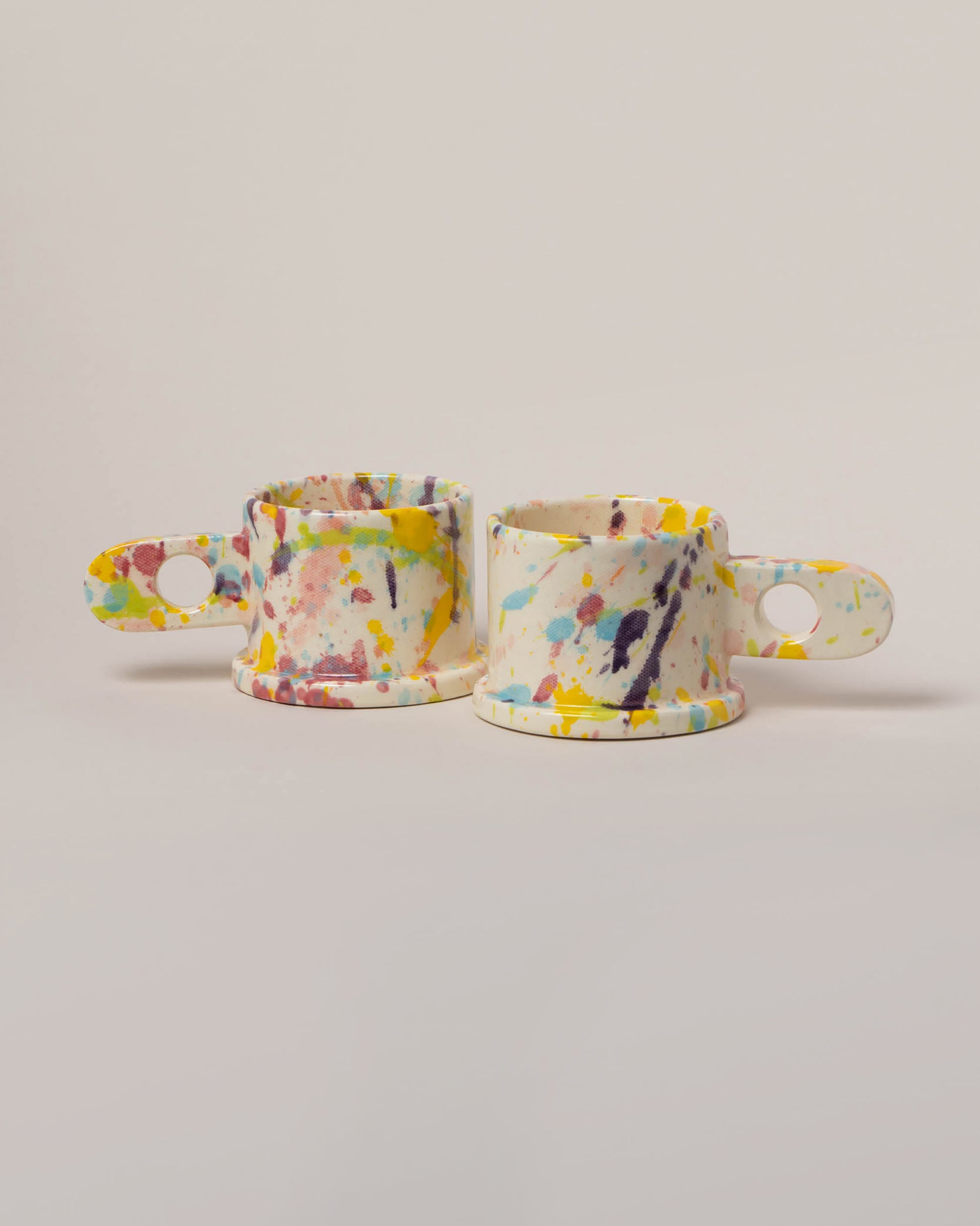 Echo Park Pottery by Peter Shire Yellow & Purple Splatter Mug Set on light color background.