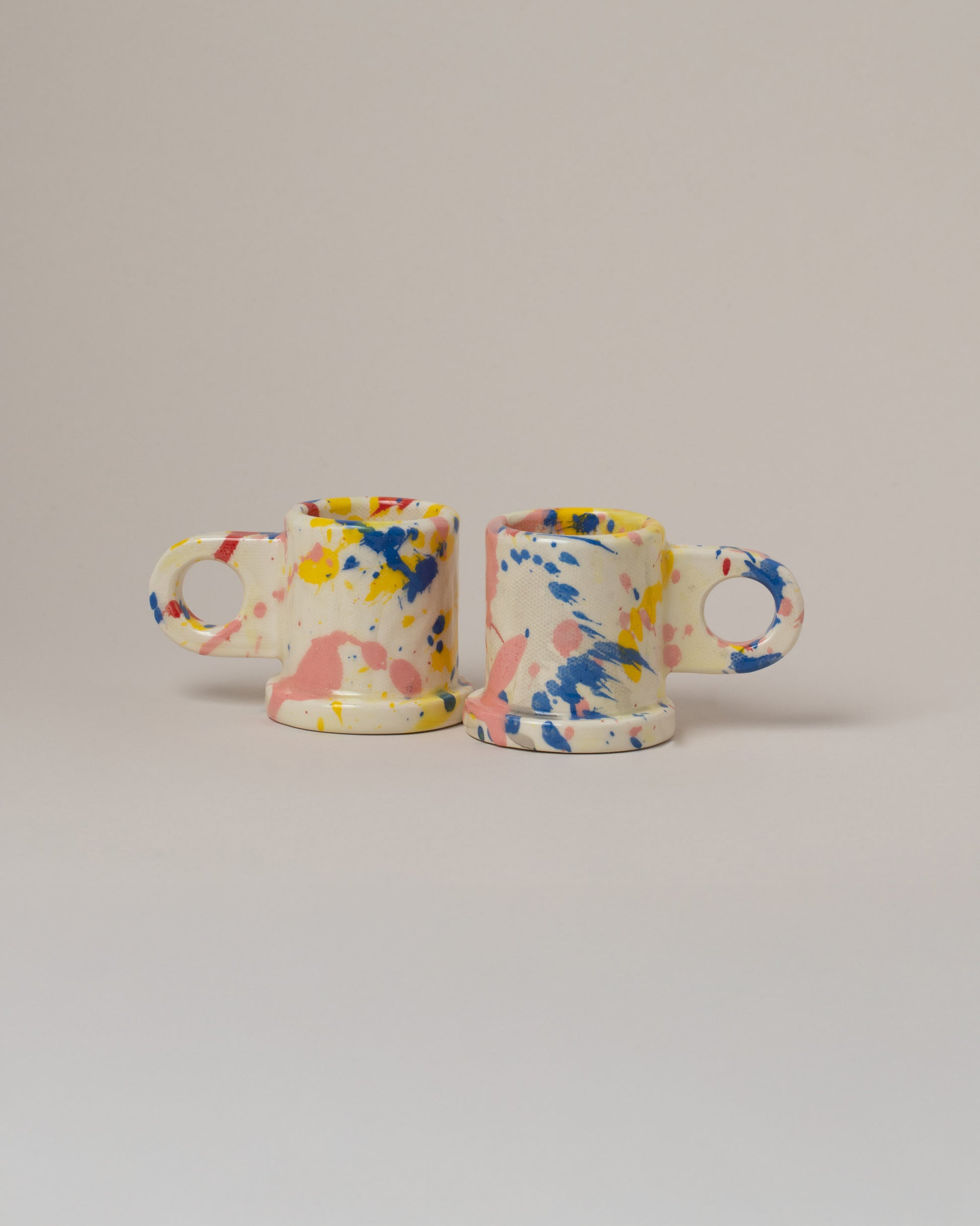 Echo Park Pottery by Peter Shire Blue & Yellow Splatter Espresso Mug Set on light color background.