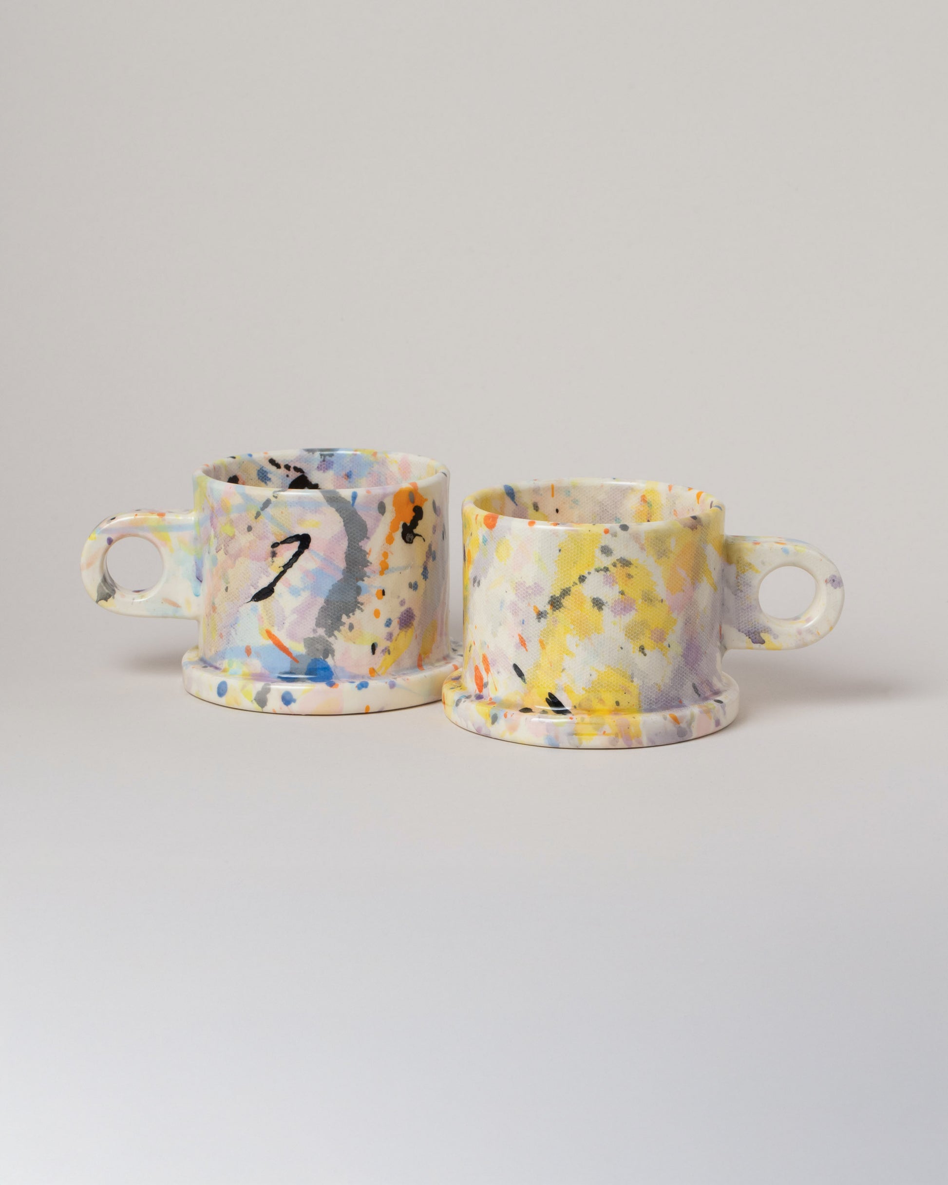 Echo Park Pottery by Peter Shire Gray & Purple Splatter Mug Set on light color background.