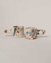 Echo Park Pottery by Peter Shire White & Brown Splatter Mug Set on light color background.