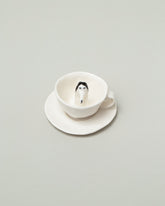 Inside view of the Eleonor Boström Espresso Dog Cup & Saucer on light color background.