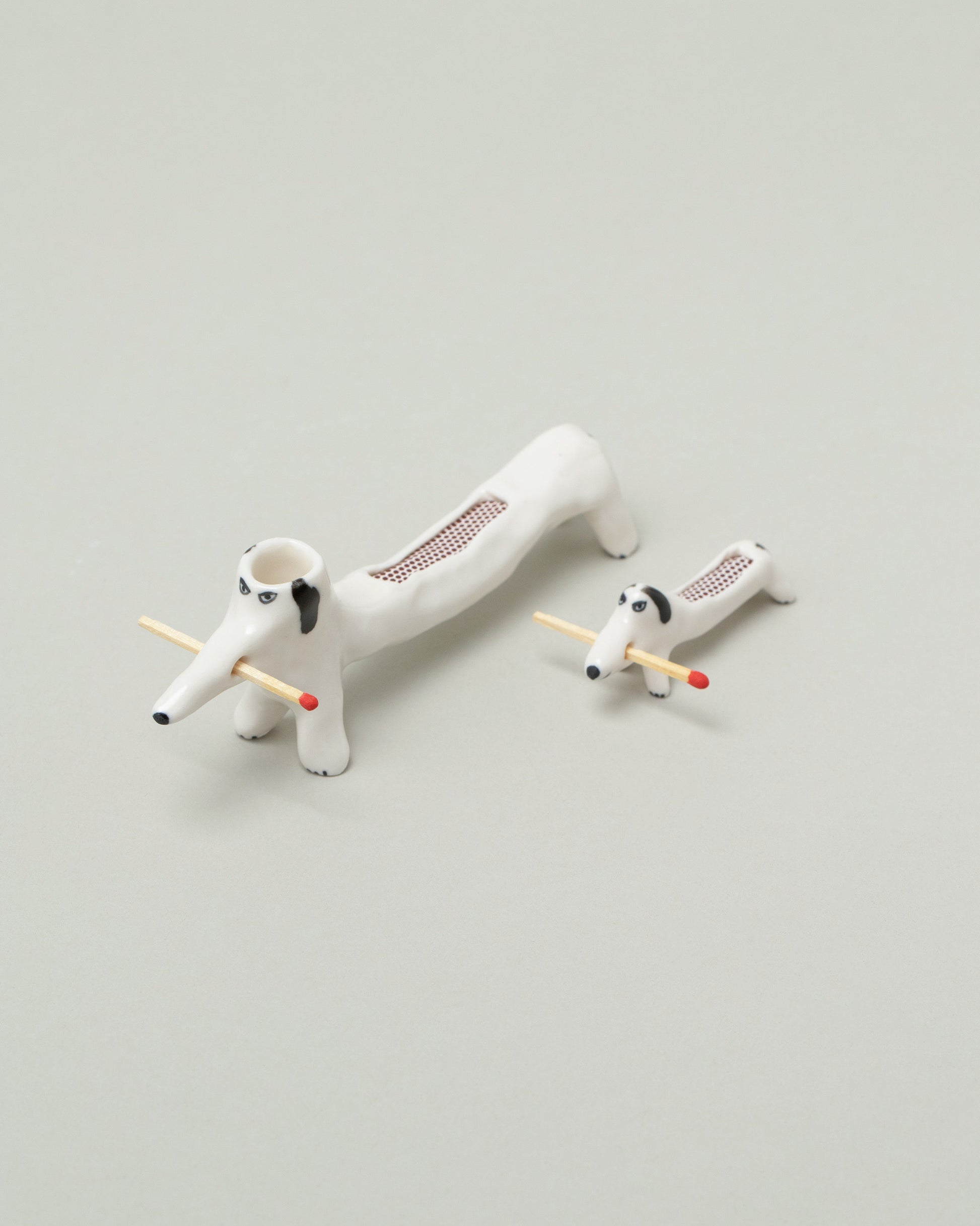 Eleonor Boström Mini Matchstick Dog and Black Matchstick Dog on light color background.