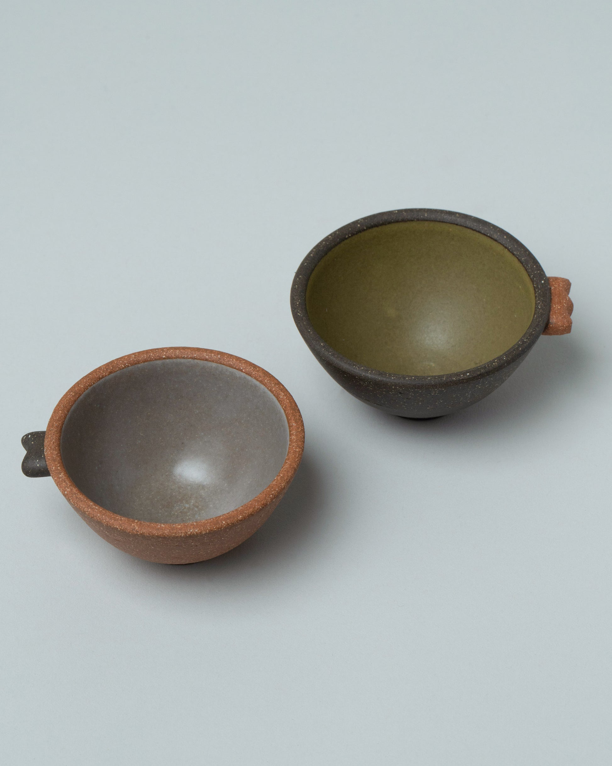 Emris Brick Clay Teenie Bowl and Dark Stoneware Teenie Bowl on light color background.