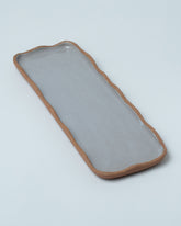 Emris Brick Clay Scalloped Tray on light color background.