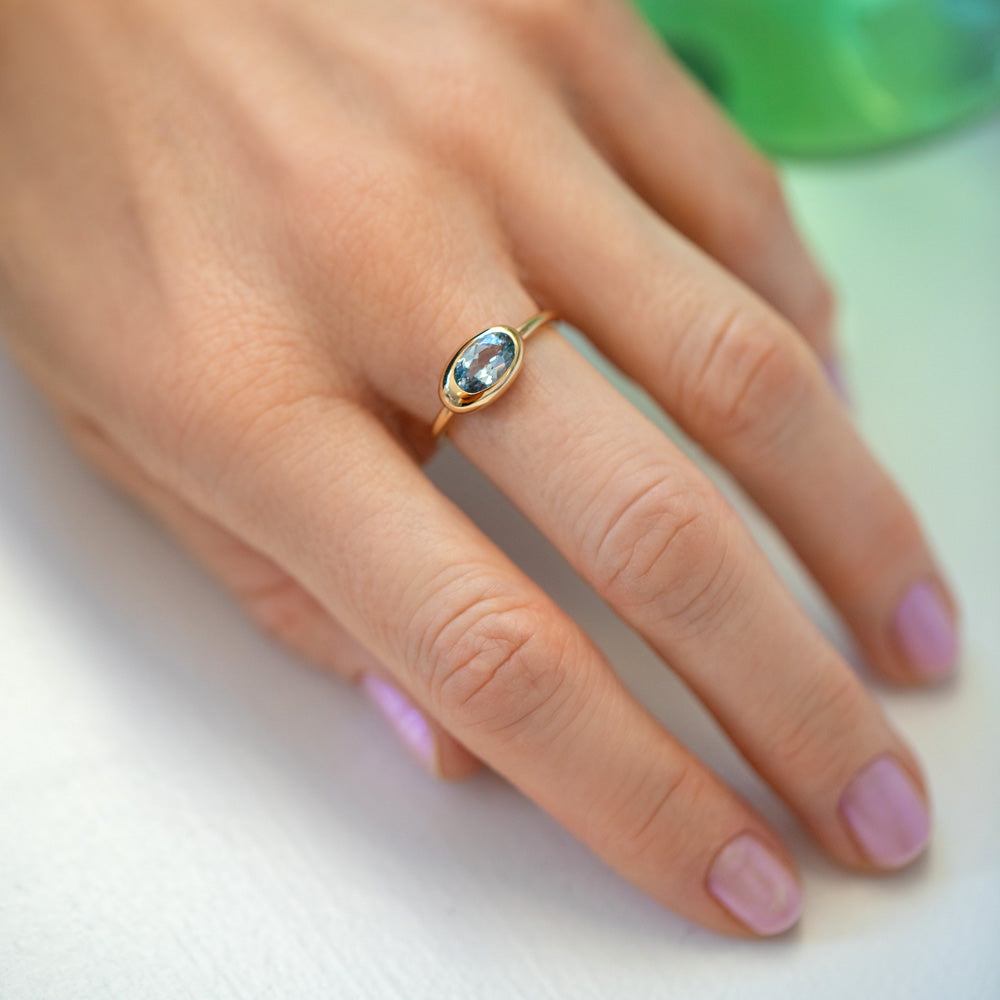 product_details::Oval Blue Sapphire Equalize Ring on model.