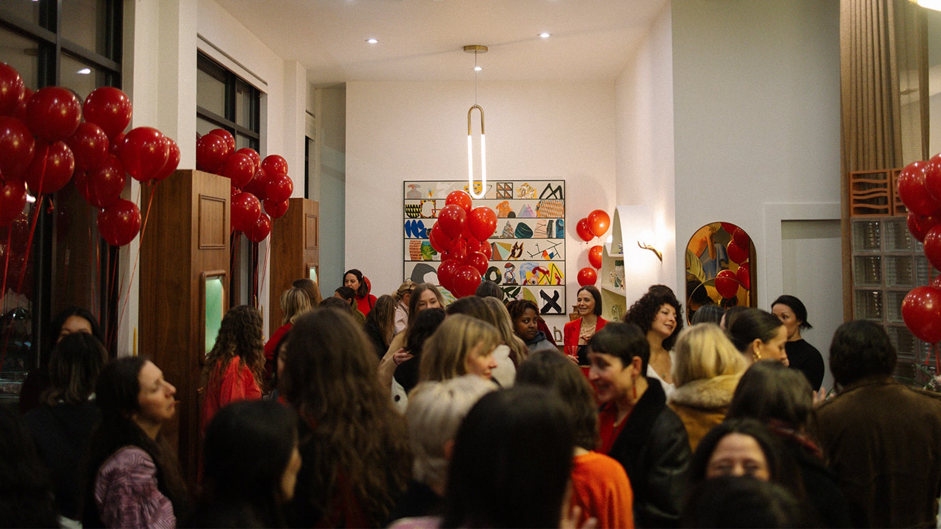 Birds-eye perspective of event attendees gathered in the Mociun Brooklyn showroom.