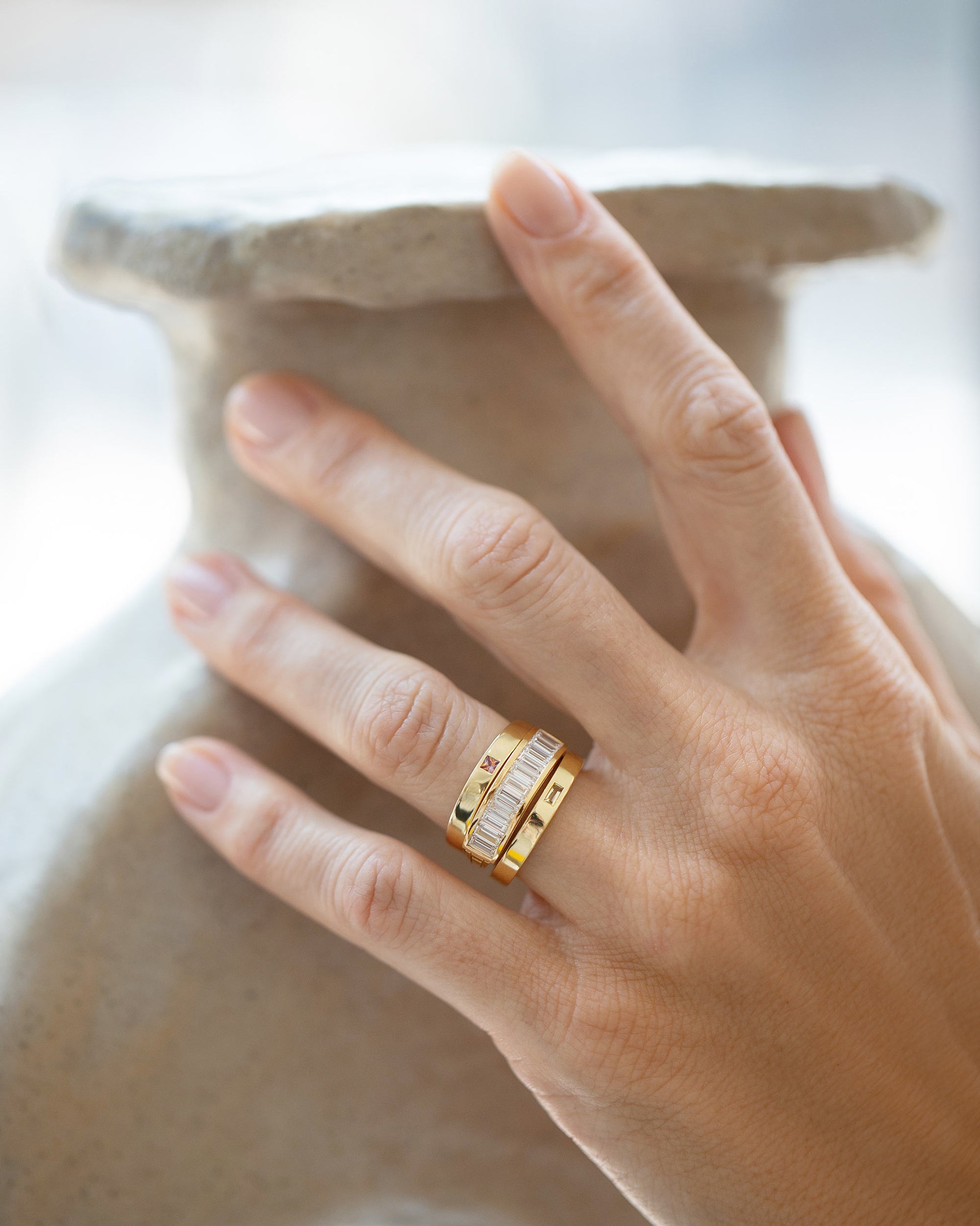 Styled image featuring the Gold Arcade Ring, Gold Bicolor Sapphire 3mm Square Cut Piet Band and Gold Yellow Beryl 3mm Baguette-Set Piet Band.