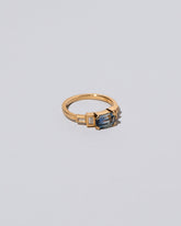 View from the side of the Blue Sapphire Expression Ring on light color background.