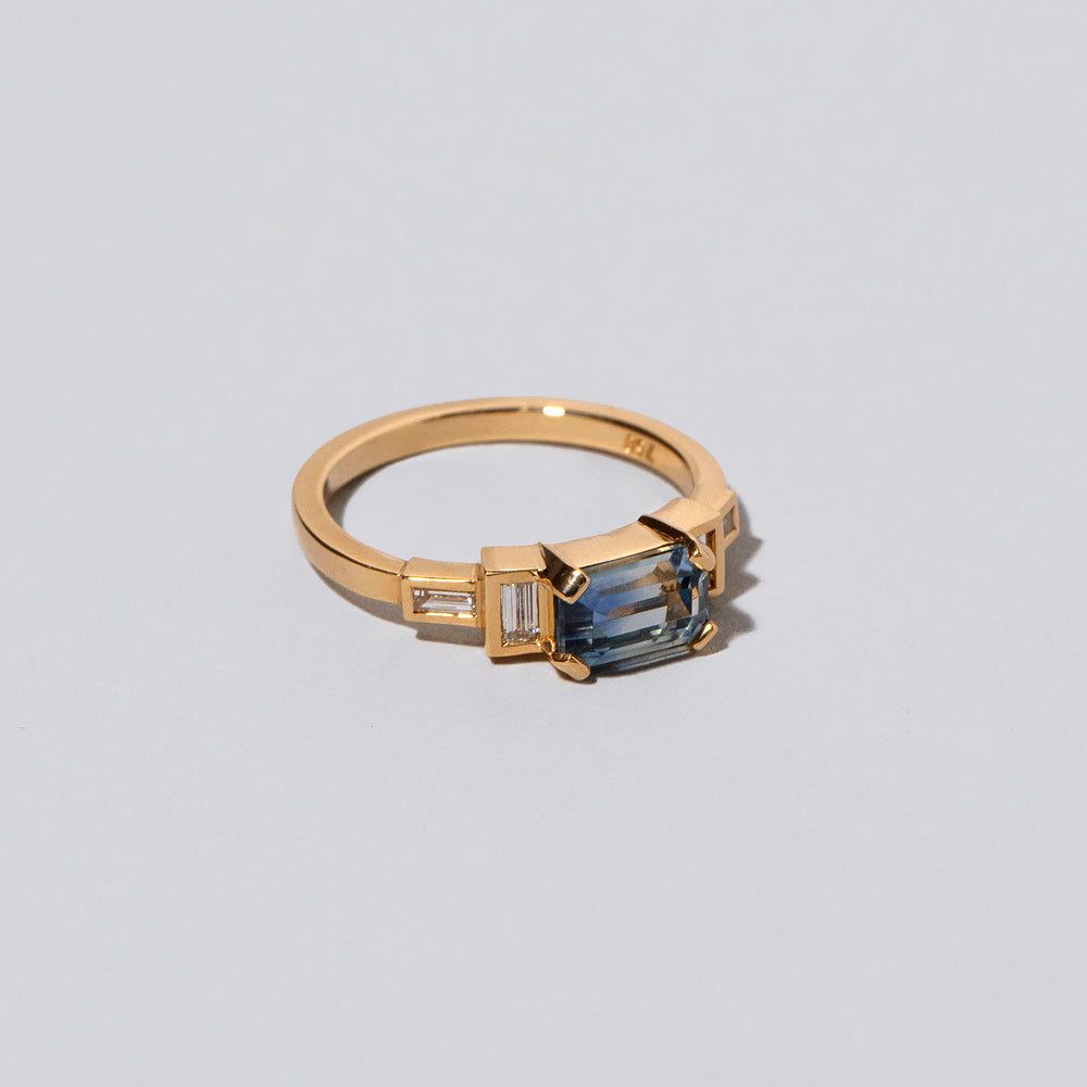 product_details::Closeup details of the Blue Sapphire Expression Ring on light color background.