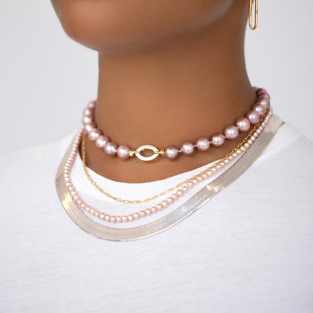 product_details::Cormorant Pearl Necklace, Hot Dog Chain Necklace, Seed Pearl Necklace and Silver Herringbone Chain on model.