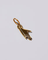 View from the side of the Carl Auböck Brass Hand Keyring on light color background.