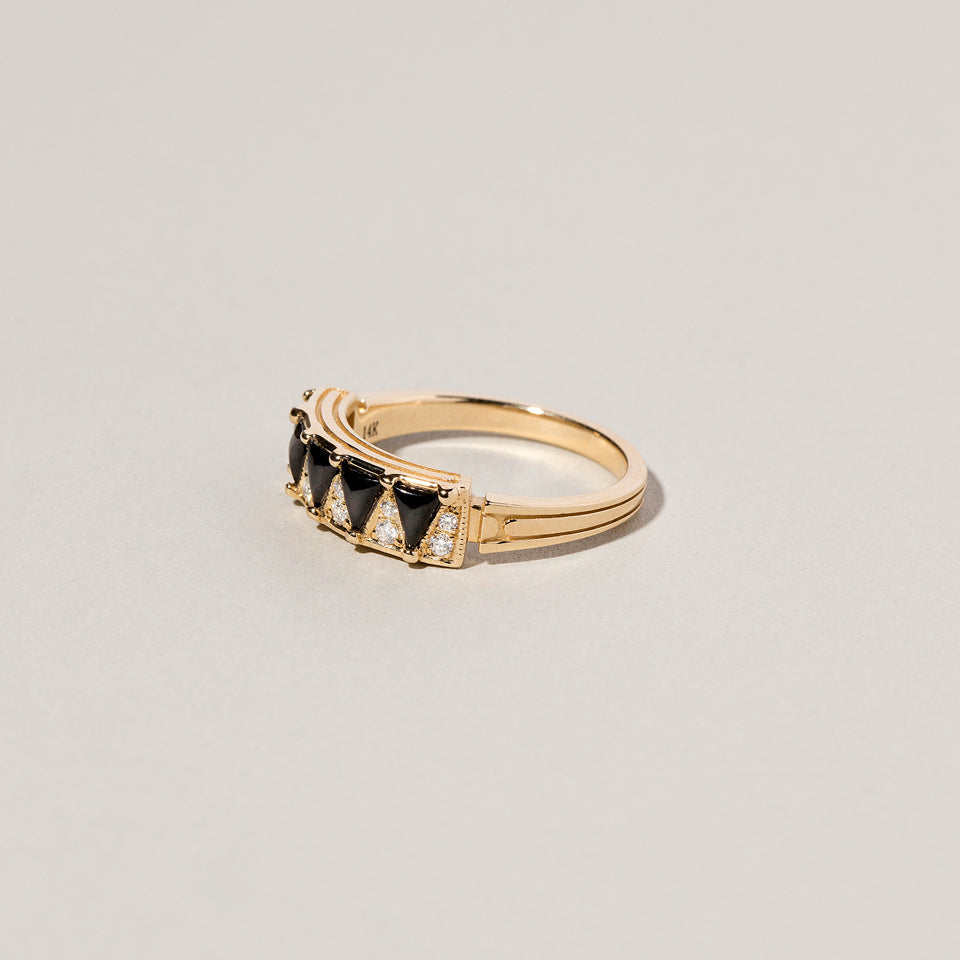 product_details::Closeup details of the Gold Black Spinel Five Triangle Ring on light color background.