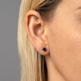 product_details::Gold Sapphire Fold Earrings on on model.