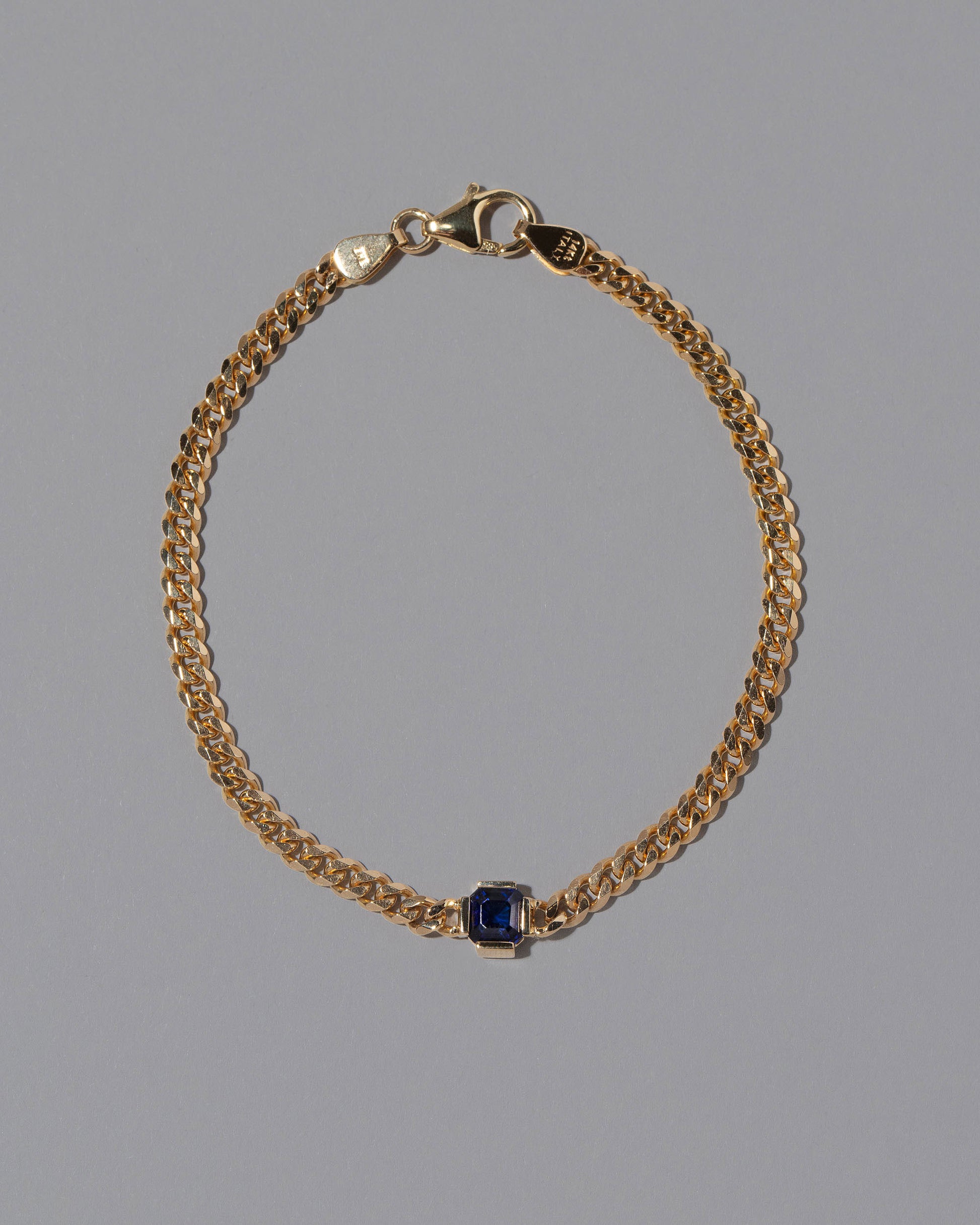 Blue Sapphire Fold Bracelet on grey color background.