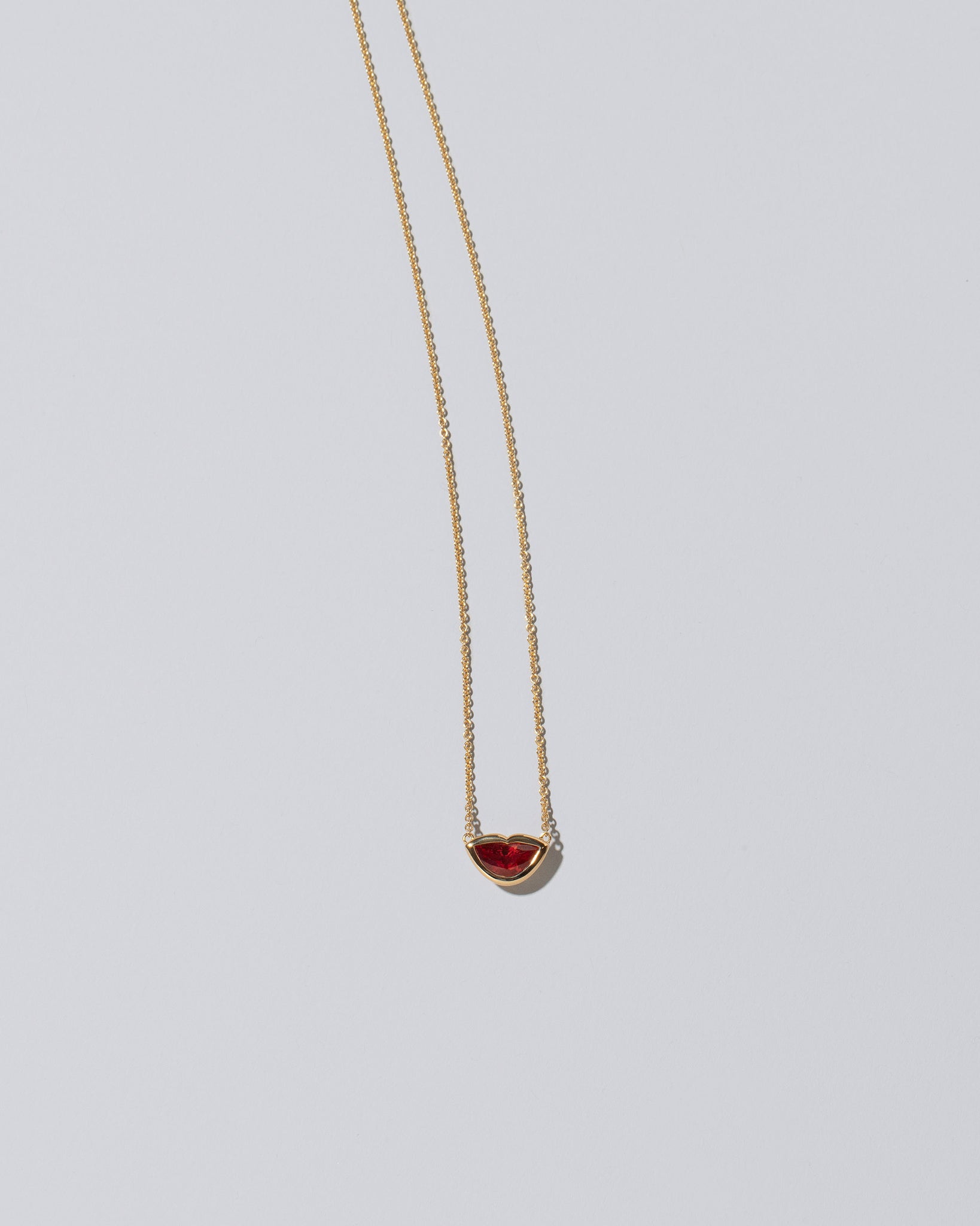 Red Spinel Lover's Kiss Necklace on light color background.