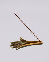 Detail view of the Carl Auböck Brass Incense Holder on light color background.