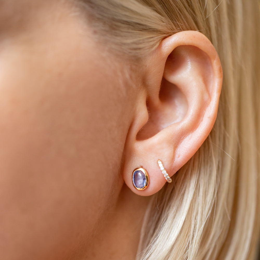 product_details::Gusher Blue Sapphire Stud Earrings 002 on model.
