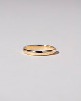 Gold 2mm Half Round Band on light color background.