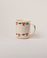 Helen Levi Lizard Christmas Mug on light color background.