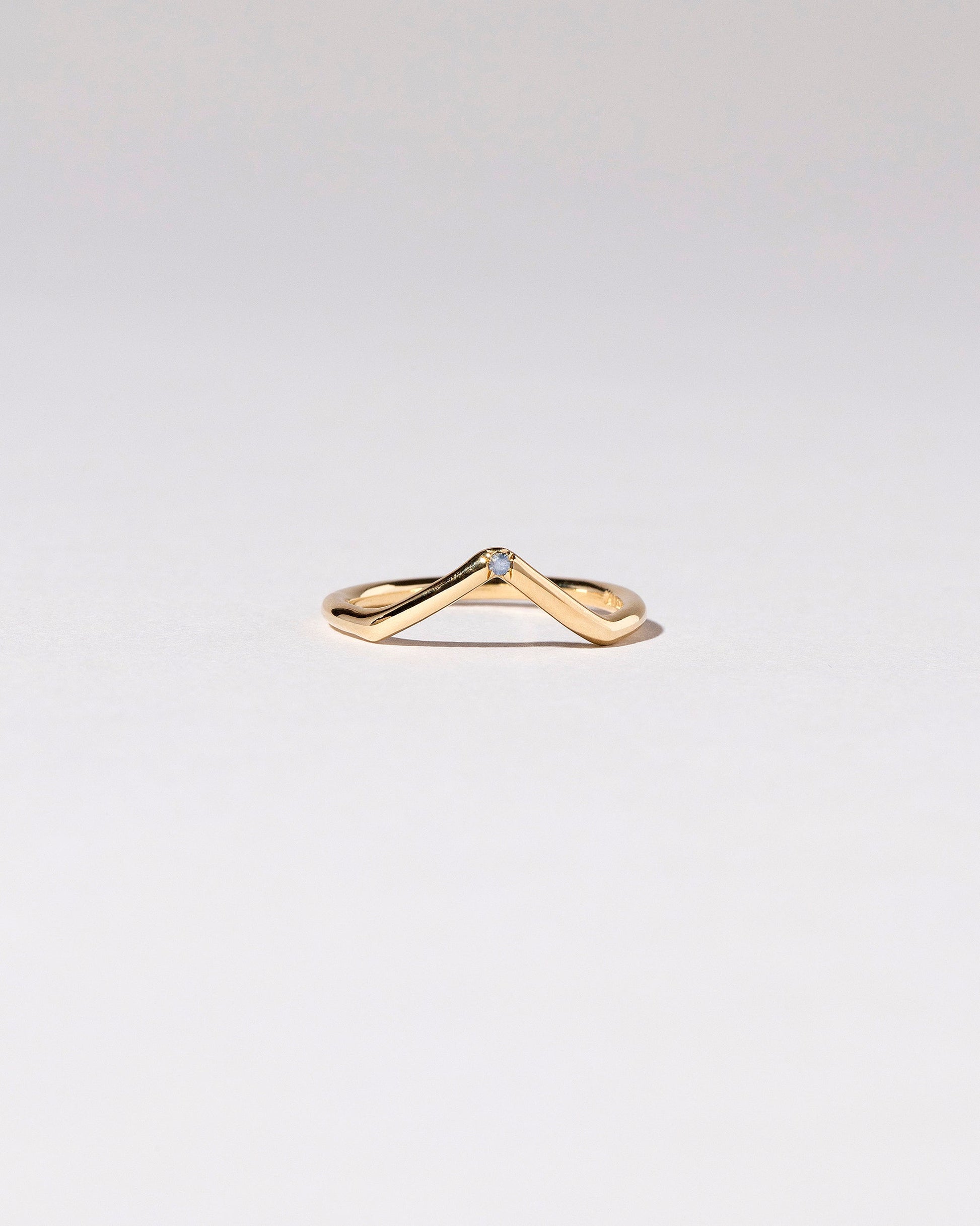 Gold Single Stone Blue Sapphire High Peak Band on light color background.