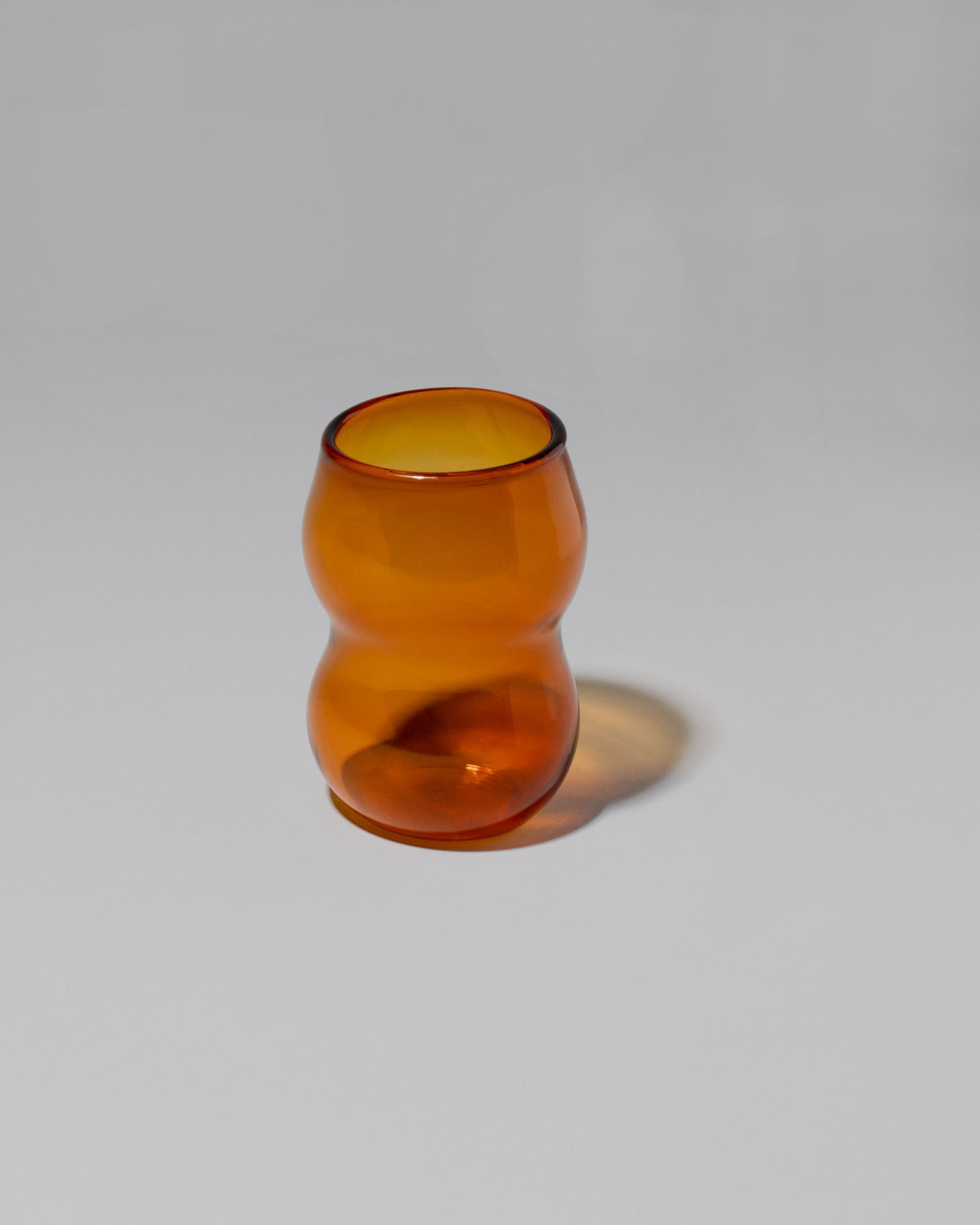 Ornamental by Lameice Amber Transparent Dreamlike Cup on light color background.