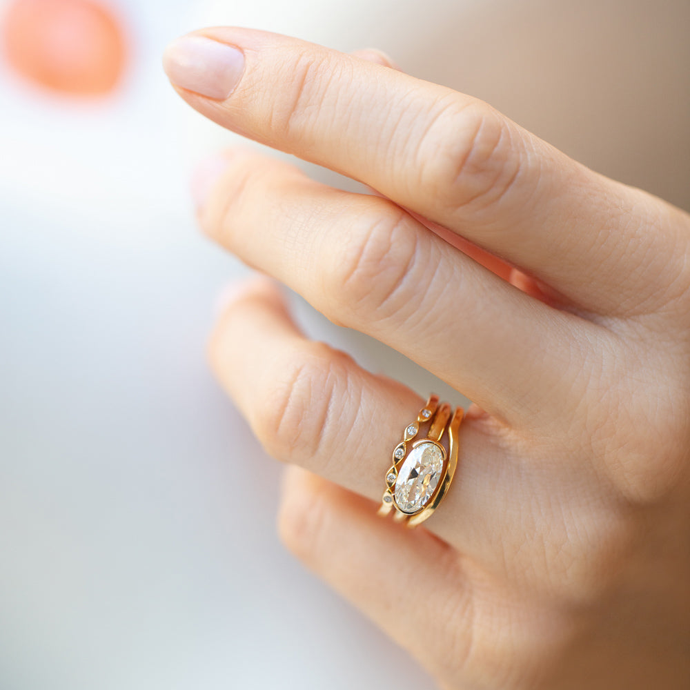 product_details::Gold Seeing Eye Band, Oval Diamond Transformation Ring and Gold Solid Bow Band on model.