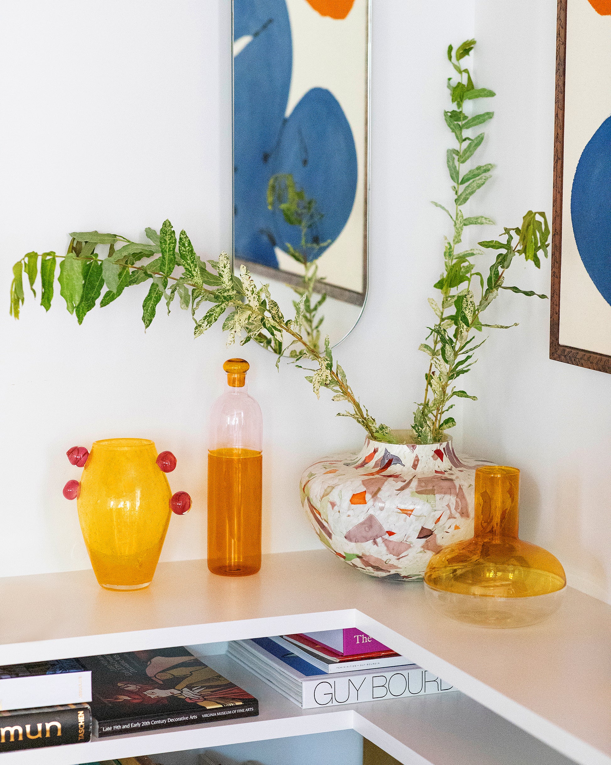 Styled image featuring the Stories of Italy Spring Nougat Glass Vase, La Romaine Editions x Sophie Lou Jacobsen Grand Le Corail Flamboyant Vase and Ichendorf Milano Pink/Amber Light Colore Bottle and Alchemy Decanter.