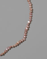 Closeup details of the Pink Peony Baroque Pearl Necklace on light color background.