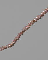 Closeup details of the Pink Peony Baroque Pearl Bracelet on light color background.