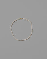 White Seed Pearl Anklet on light color background.