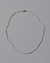 White Oval Pearl Necklace on light color background.