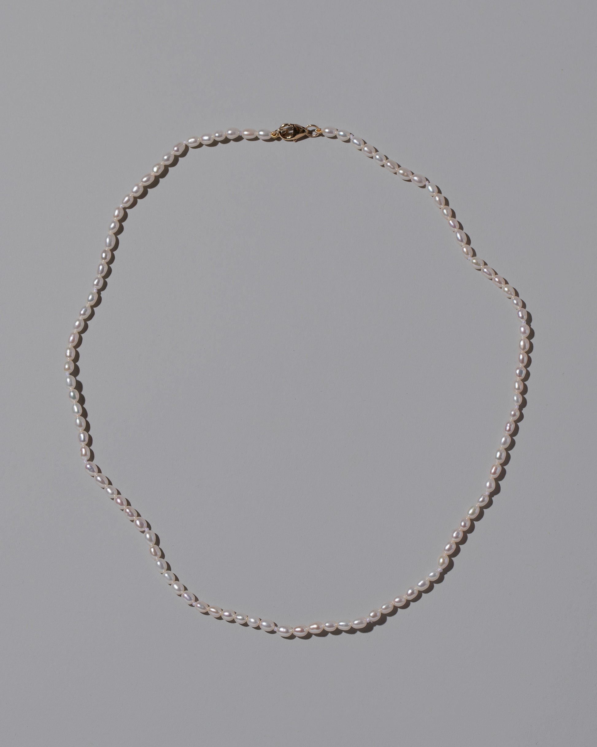 White Oval Pearl Necklace on light color background.