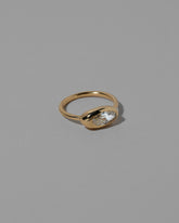 View from the side of the Moval White Diamond Equalize Ring on light color background.