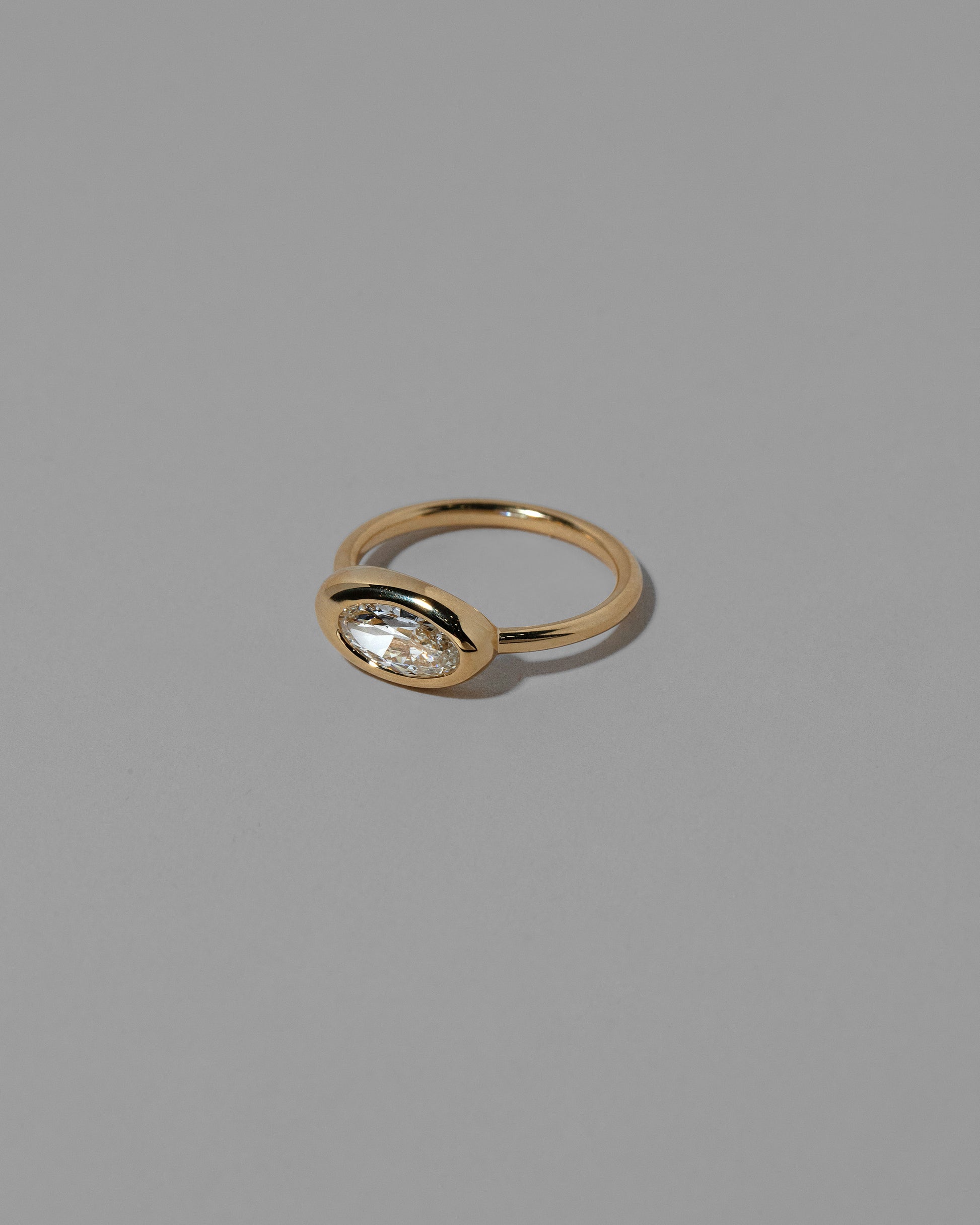 View from the side of the Moval White Diamond Equalize Ring on light color background.