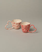 Group of La Romaine Editions x Samantha Kerdine Pink and Red Heart-shaped Cups on light color background.