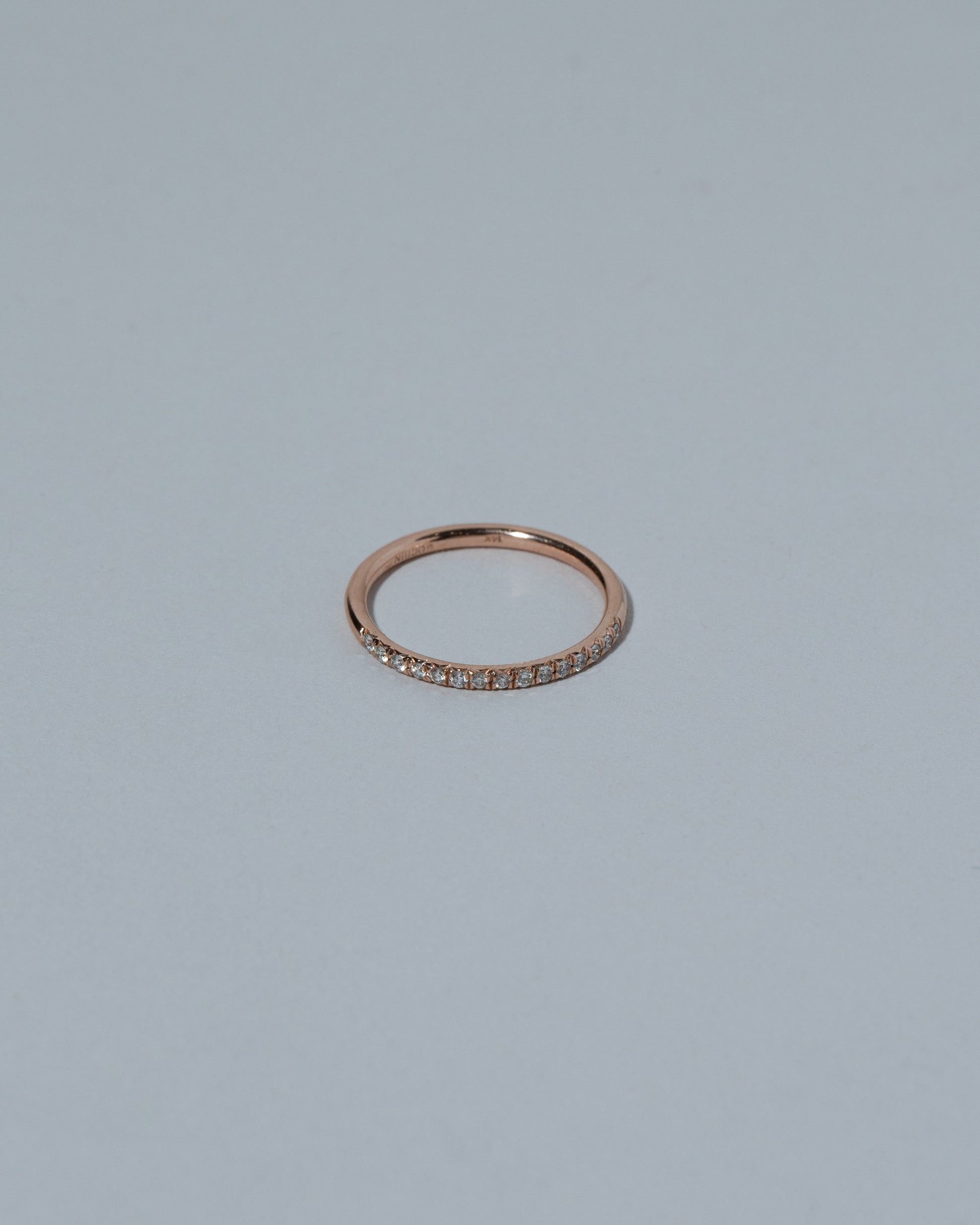 Rose Gold Fifteen Stone Diamond Dot Band on light color background.