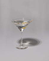 Spills Olives Martini on light color background.