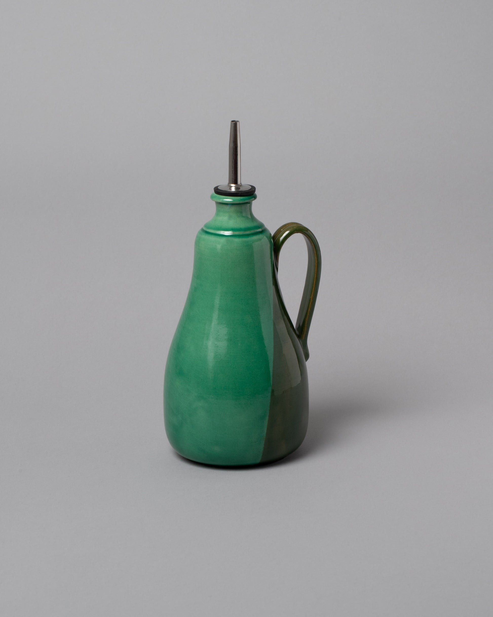 La Ceramica Vincenzo Del Monaco Green Oil Bottle on light color background.