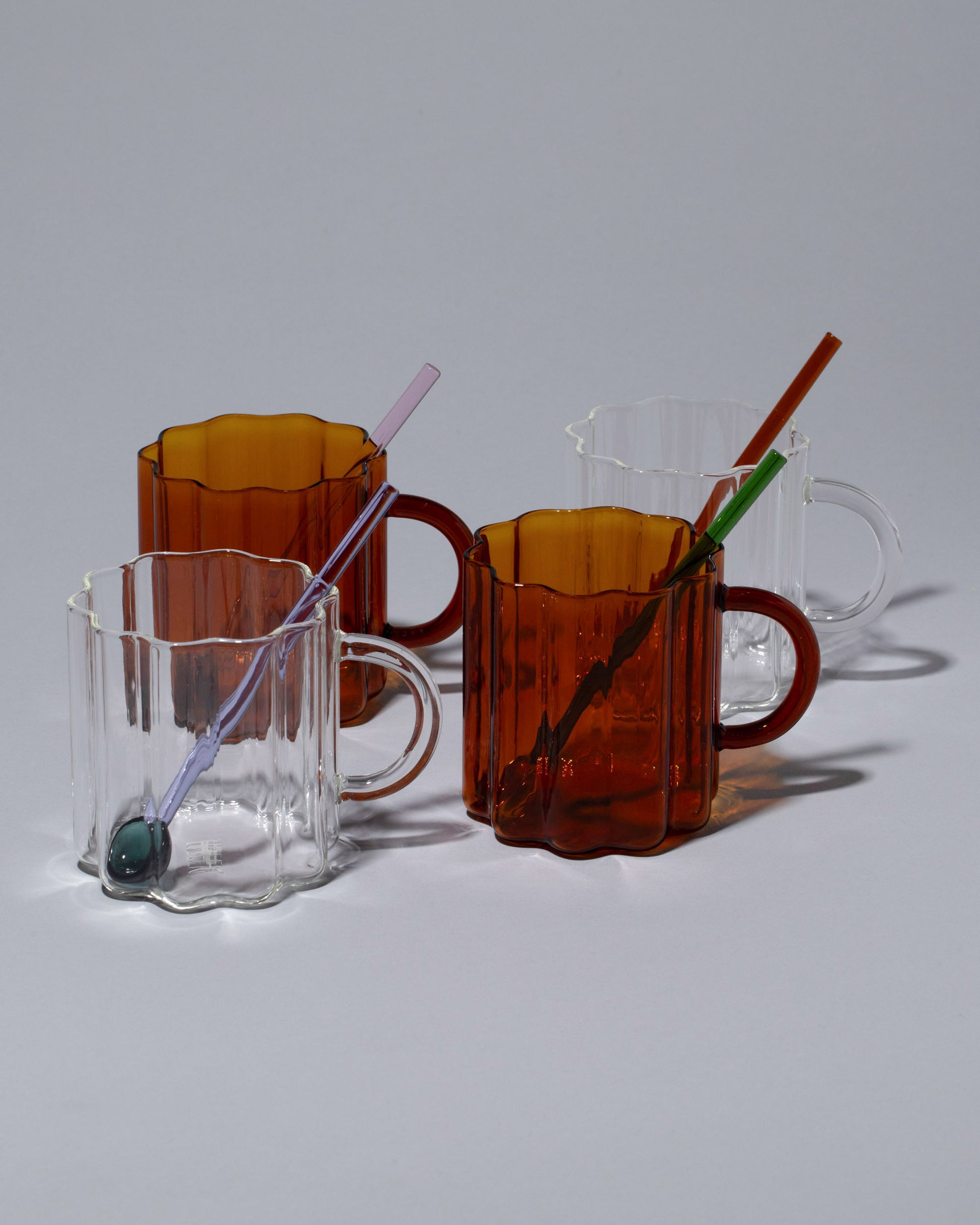 FAZEEK Coffee & Tea Set, including the Amber and Clear Wave Mugs, and the Teaspoons Set on light color background.