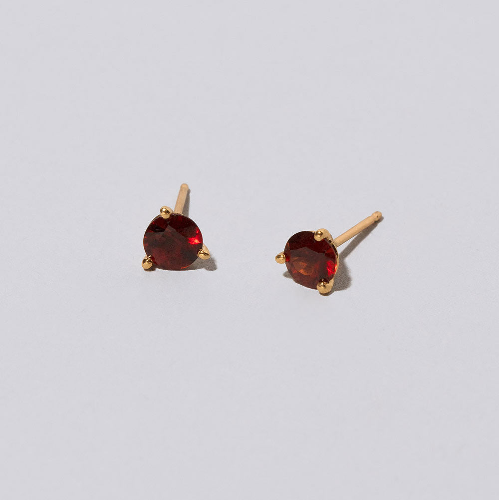 product_details::Mega Red Garnet Martini Stud Earrings on light color background.