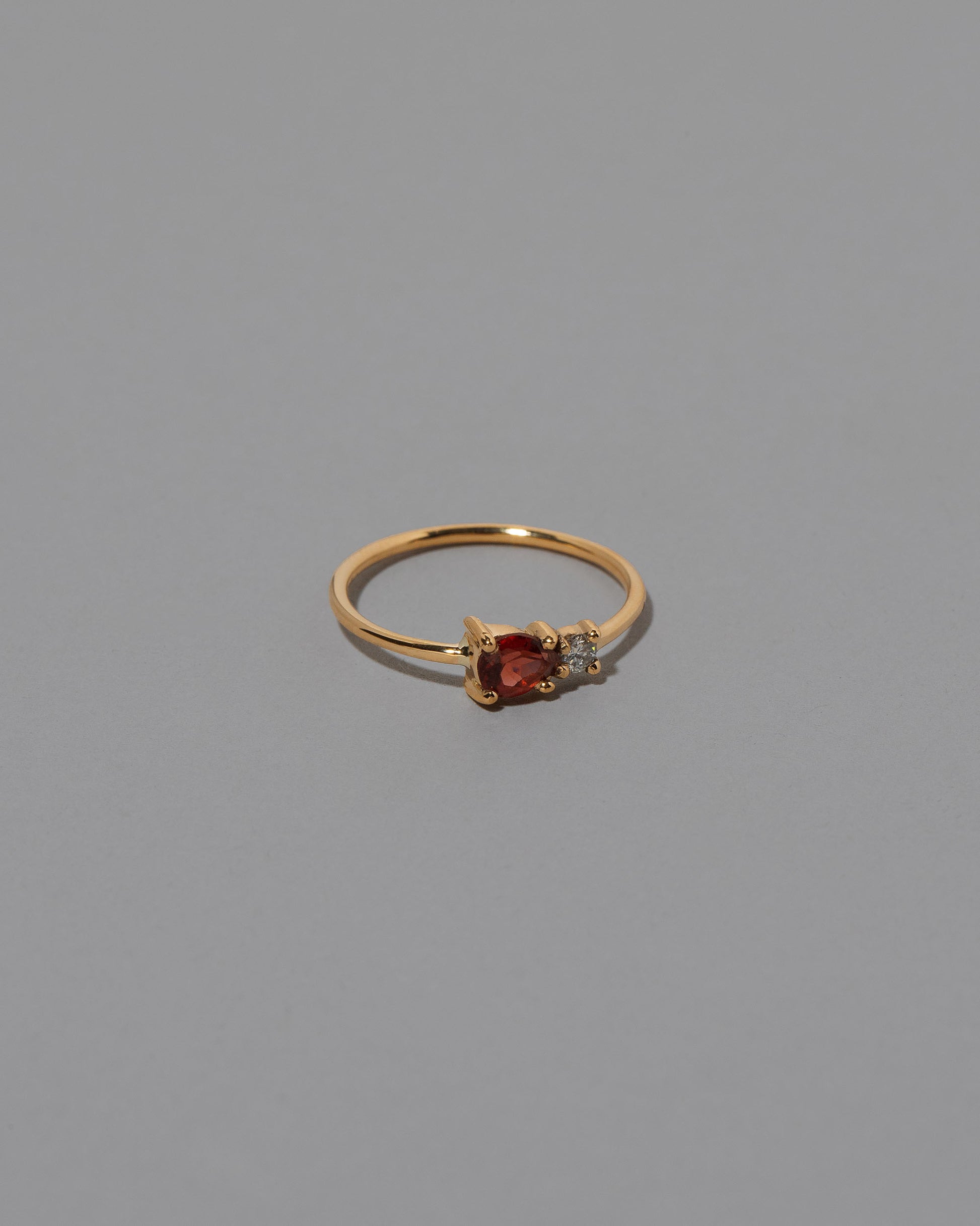 Red Garnet Teardrop Ring on light color background.