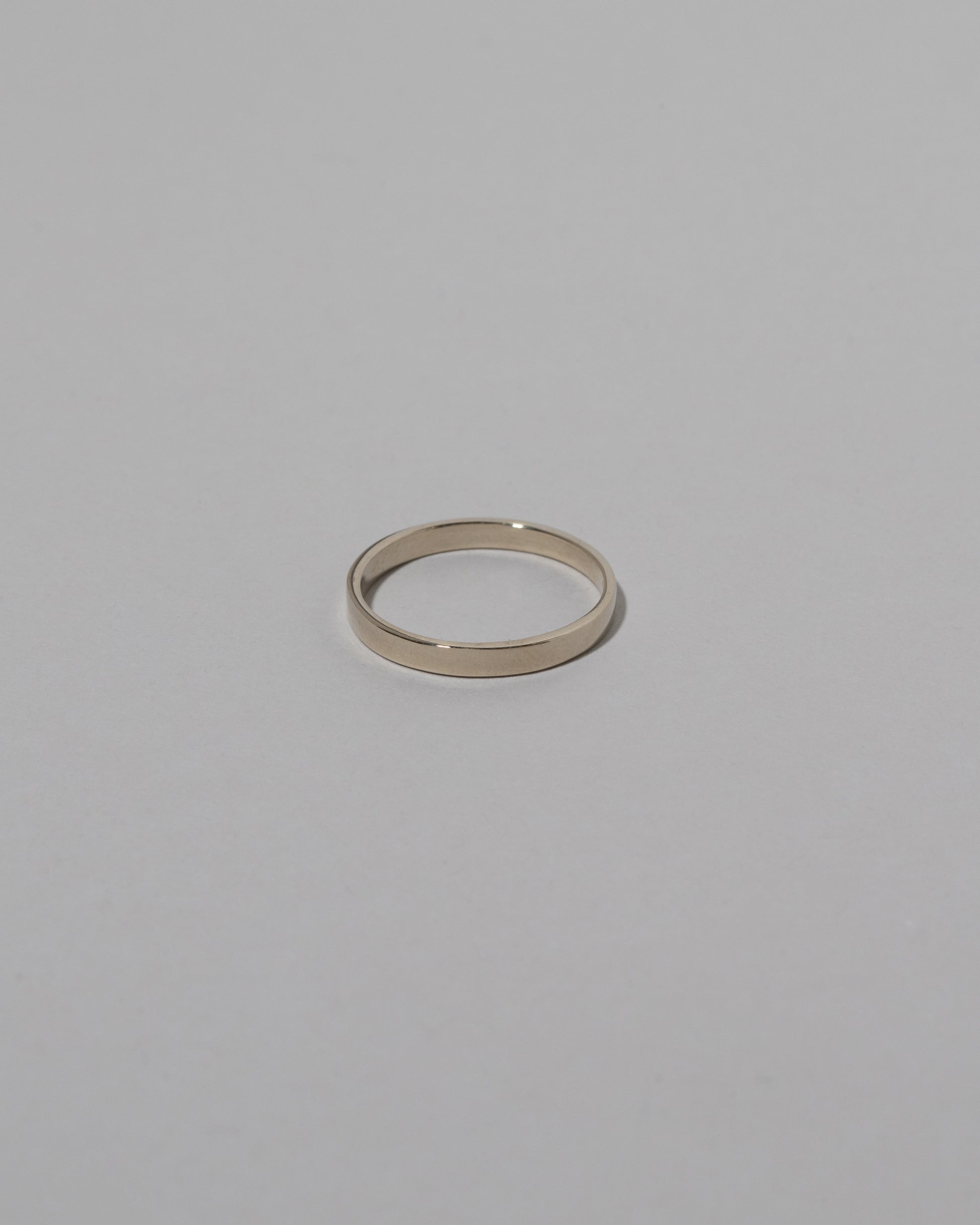 Samples & Imperfects 2.6mm White Gold Square Wire Band on light color background.