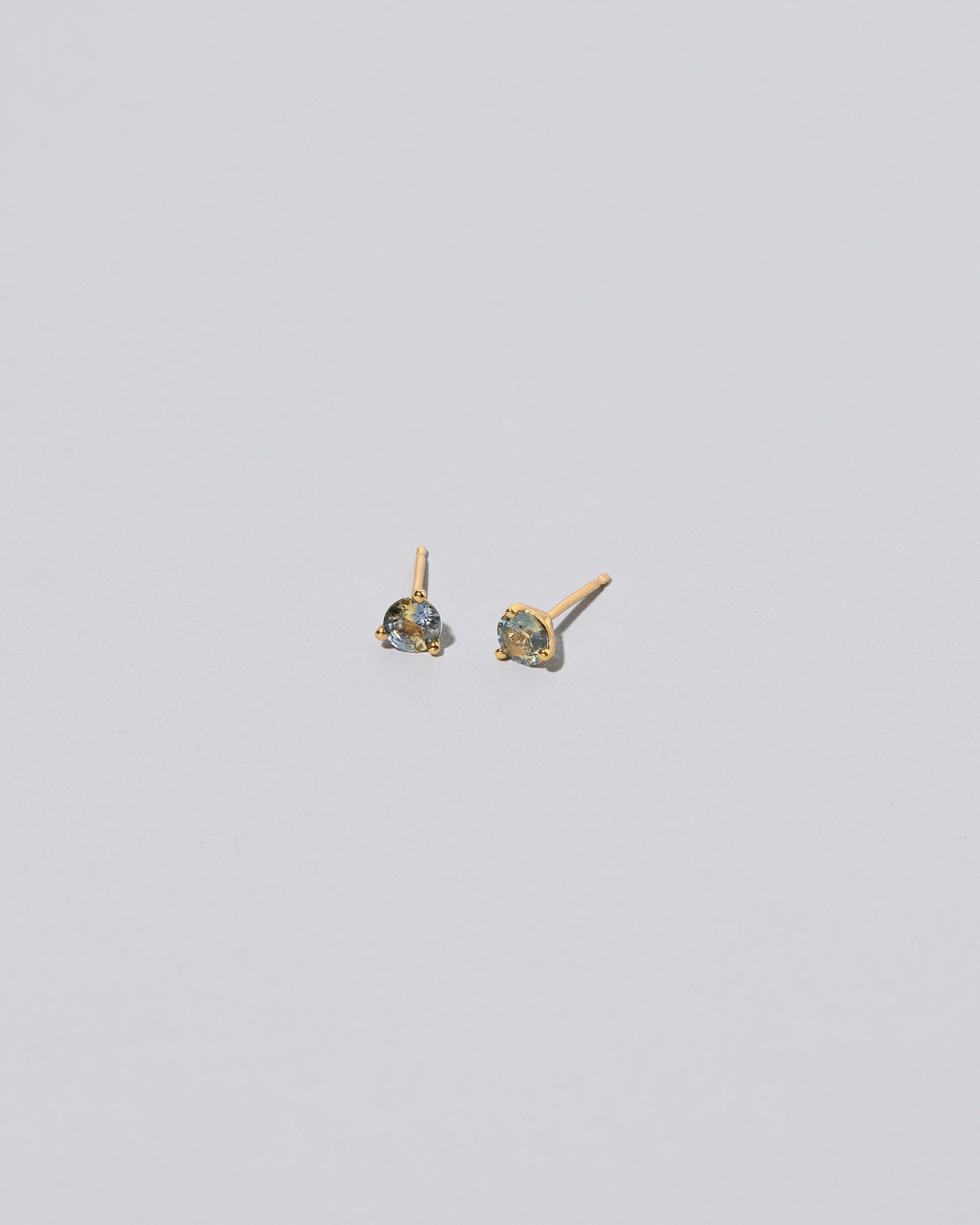 Martini Stud Earrings - Bicolor Yellow/Blue Sapphire on light color background.