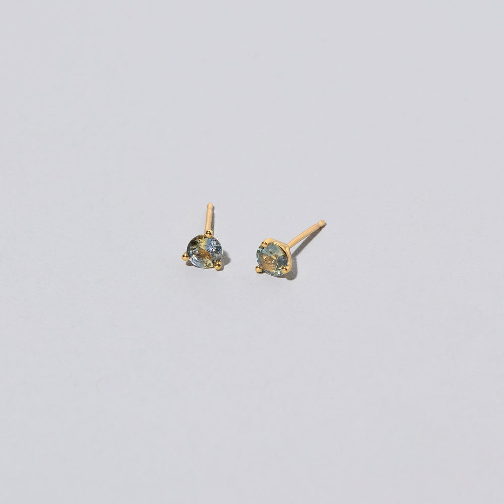 product_details::Martini Stud Earrings - Bicolor Yellow/Blue Sapphire on light color background.