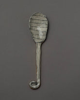 Suzanne Sullivan Idea For Reuse Serving Spoon on grey color background.